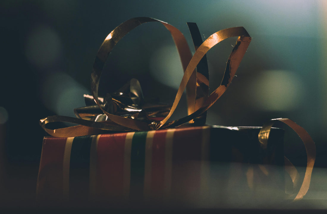 a picture of a gift box knotted with a butterfly knot. dark light and blurry light in the background