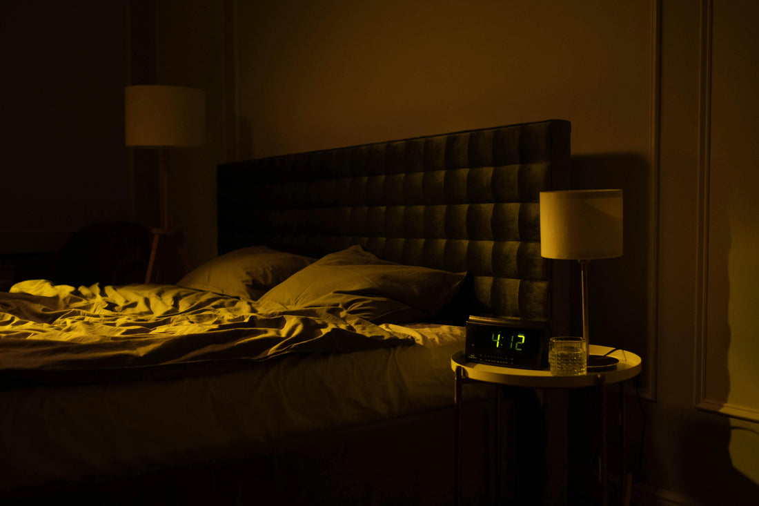 ozy modern bedroom at night with ambient lighting, digital clock reading 4:12 AM, and a soft upholstered headboard – perfect peaceful sleep space inspiration.