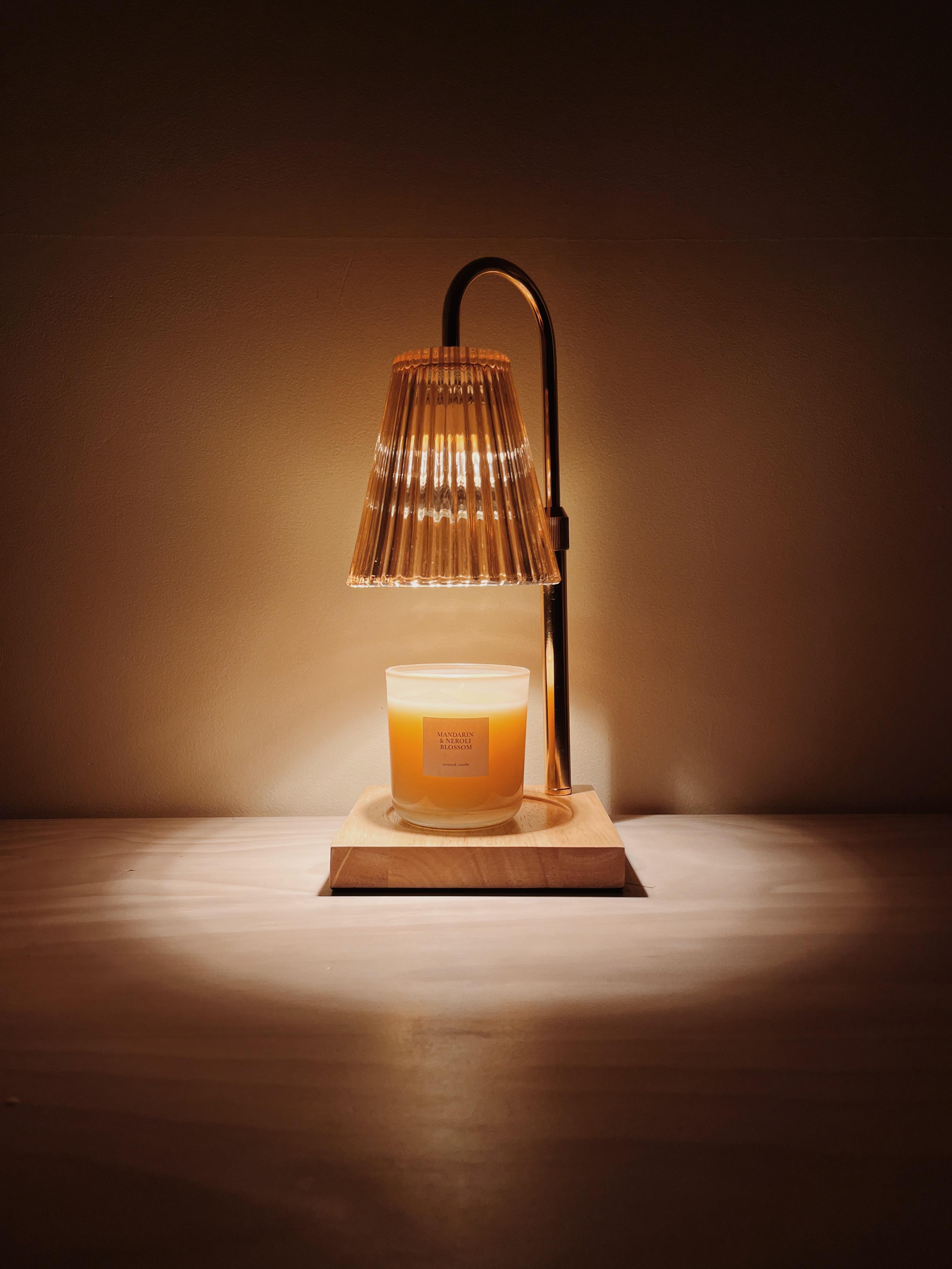 Auren Elegance candle warmer lamp with a ribbed glass shade gently melting a scented candle on a wooden base, perfect for minimalist home decor and cozy ambiance.